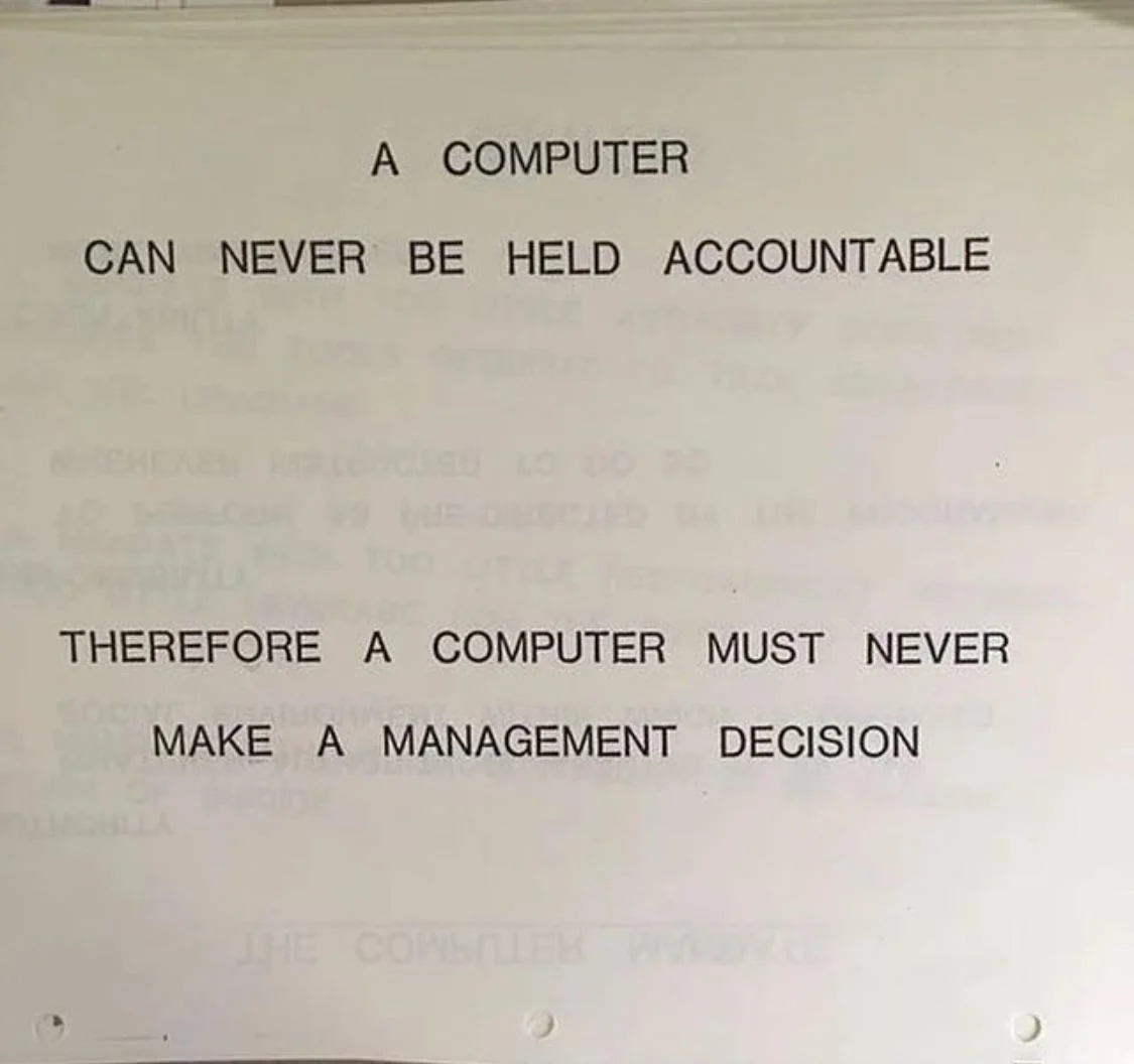 A picture of an IBM manual saying that a computer can never be held accountable, and so a computer can never make a management decision.